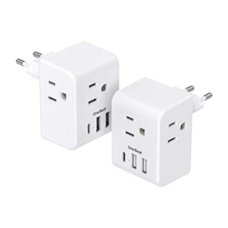 Two white universal travel adapters with dual plugs and USB ports.